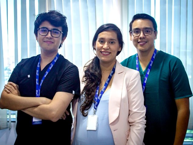 Three members of the NaviCall team standing together in an office